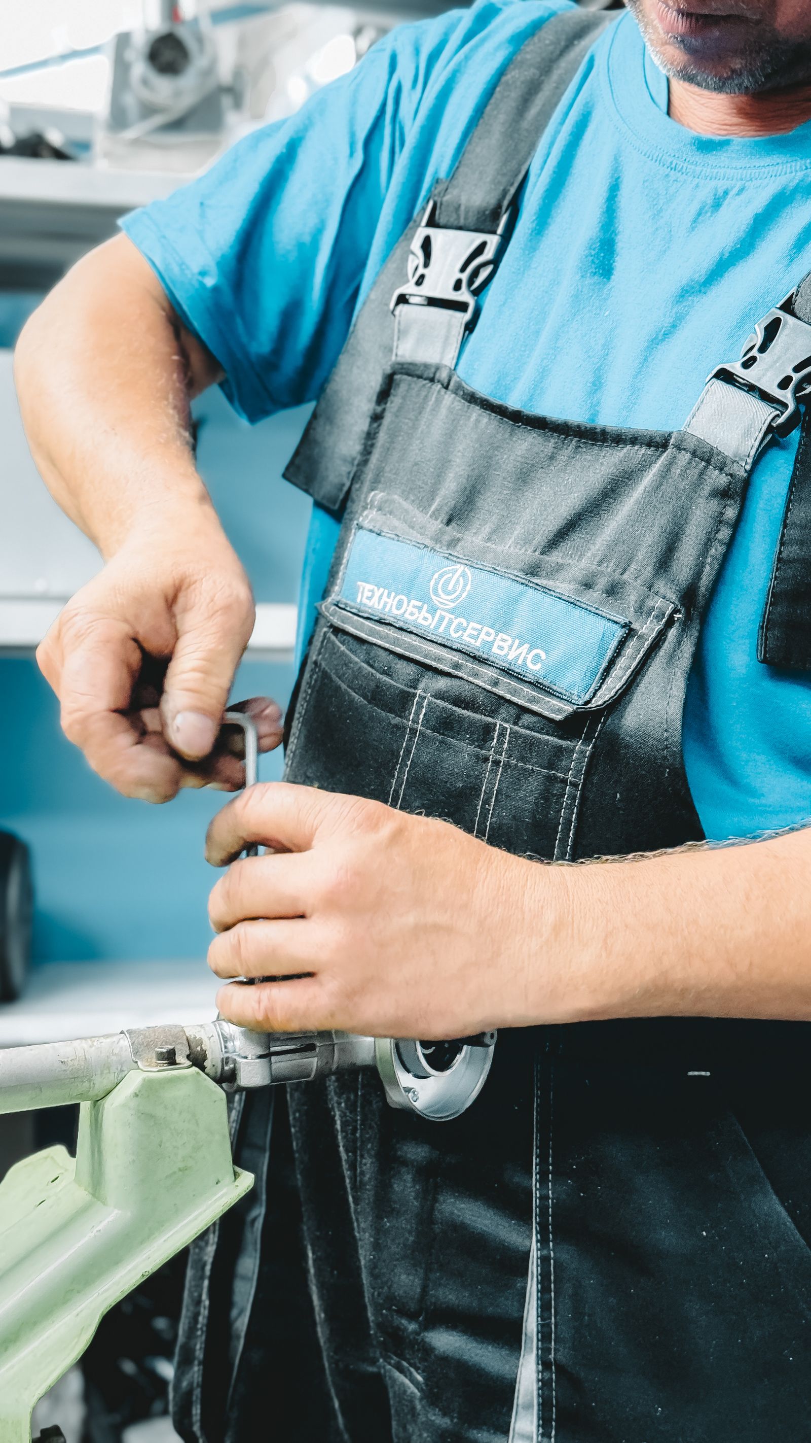 Professional plumber working beneath a sink